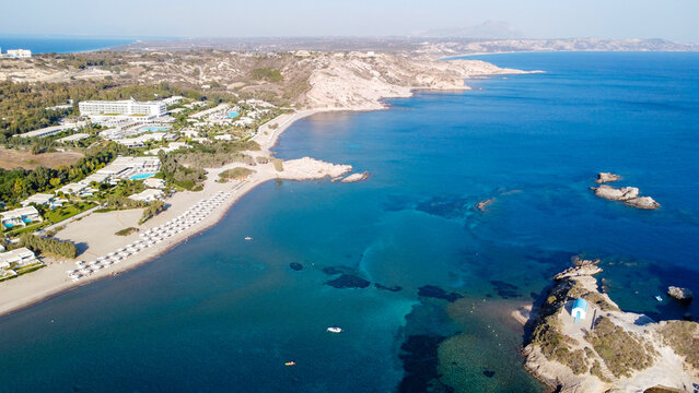 Aerial High Angle View of Agios Stefanos Beach and Kastri Islet with Ancient Ruins and Luxury Resort in Kos Greece