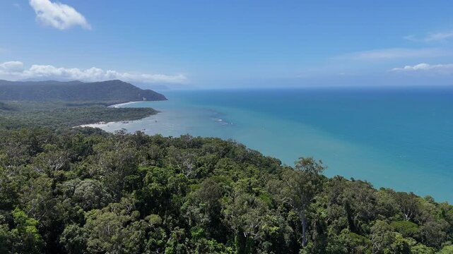 drone shot of beautiful bloomfield road through the daintree rainforest near cape tribulation along the tropical coastline of the pacific ocean in Queensland, a popular travel destination in Australia