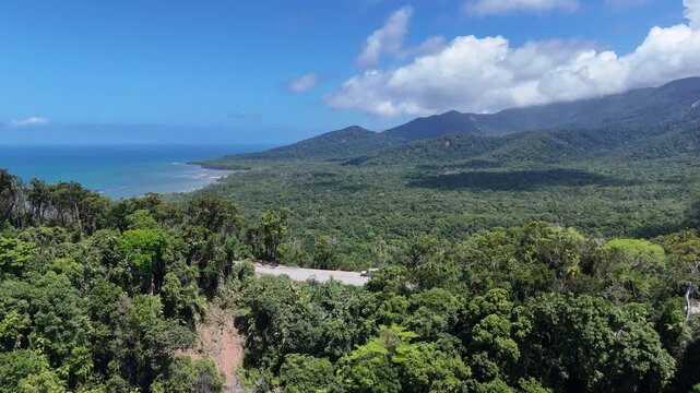 drone shot of beautiful bloomfield road through the daintree rainforest near cape tribulation along the tropical coastline of the pacific ocean in Queensland, a popular travel destination in Australia
