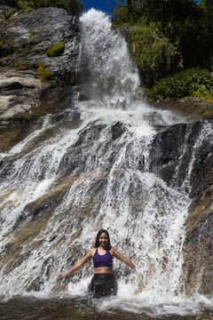 Latina mountaineers in front of a waterfall in the eastern part of Waraira Repano National Park in Guatire. Hiking in Latin America and the Caribbean. Exploring Venezuela