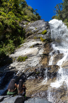 Mountaineers in front of a waterfall in the eastern part of Waraira Repano National Park in Guatire. Hiking in Latin America and the Caribbean. Exploring Venezuela