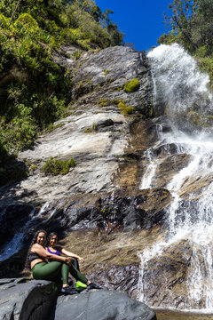 Mountaineers in front of a waterfall in the eastern part of Waraira Repano National Park in Guatire. Hiking in Latin America and the Caribbean. Exploring Venezuela
