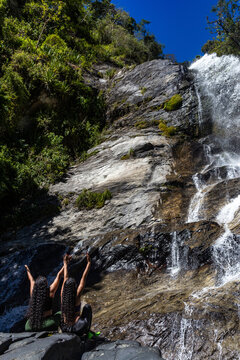 Mountaineers in front of a waterfall in the eastern part of Waraira Repano National Park in Guatire. Hiking in Latin America and the Caribbean. Exploring Venezuela