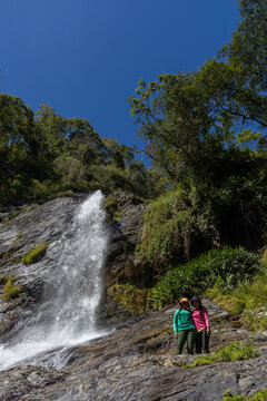 Latina mountaineers in front of a waterfall in the eastern part of Waraira Repano National Park in Guatire. Hiking in Latin America and the Caribbean. Exploring Venezuela