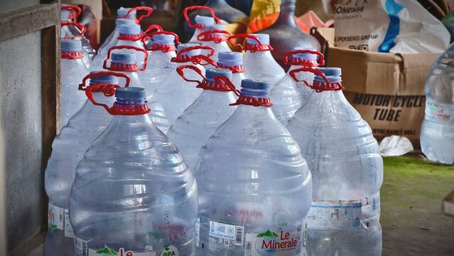 Rows of large clear plastic bottles brimming with refreshing drinking water, securely capped and ready for essential hydration or emergency storage needs