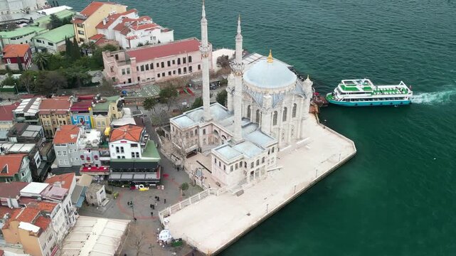 The Grand Mecidiye Ortakoy Mosque view with the Martyrs Bridge zoom rotation
