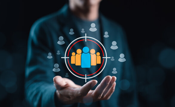 Audience Targeting and Customer Reach Concept. Person presenting a target audience icon with user symbols, representing customer segmentation, audience selection, market targeting and focused outreach