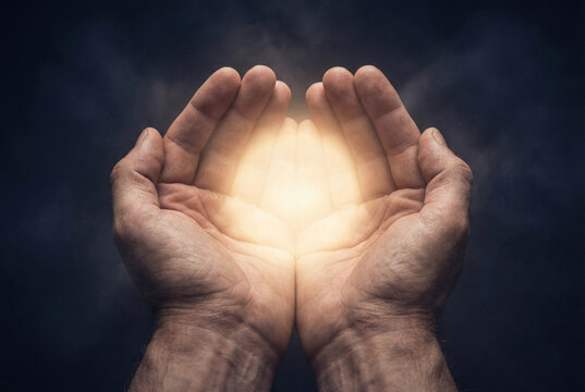 Hands holding a glowing sphere of light