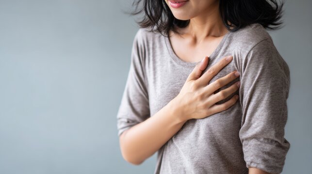 hand hold chest with heart attack symptoms, working hard have chest pain caused by heart disease, leak, dilatation, enlarged coronary heart, press on the chest with a painful expression