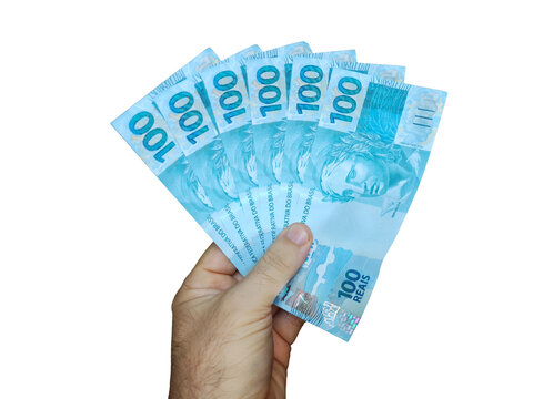 Hand holding Brazilian 100 reais banknotes isolated