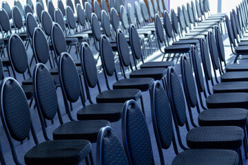 Fototapeta premium Rows of empty conference chairs arranged for an event