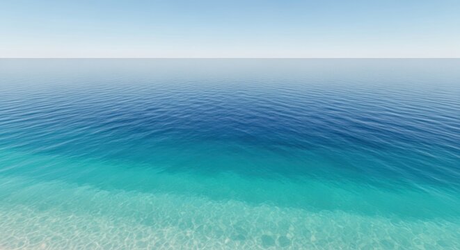 Calm ocean waves gently lap against the sandy shore under clear blue skies