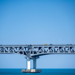 Obraz premium Railway bridge over the sea with blue sky in summer day.