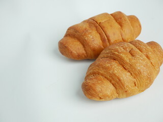 Fototapeta premium Golden brown fresh croissants on white background
