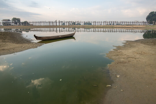 A local boat in Taungthaman Lake near U Bein Bridge the longest teak bridge in the world in Amarapura, Myanmar.