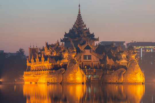 Beautiful Karaweik Palace in Yangon township of Myanmar at dawn. Karaweik Palace is designed as a concrete replica of a traditional golden royal barge. Opened in 1974.