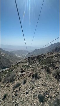 Aerial Cable Car Ride Over Rocky Mountain Landscape in Taif, Saudi Arabia