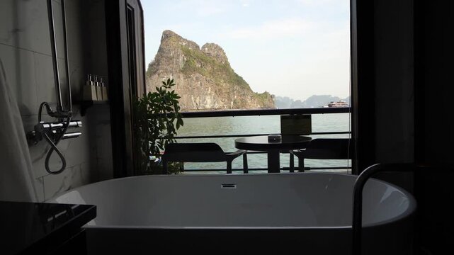 Luxury bathroom with ocean and mountain view from window