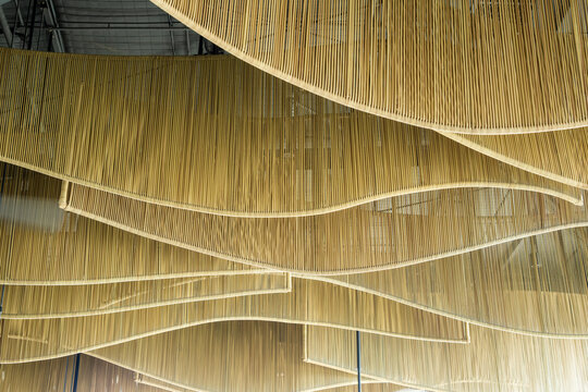 Abstract ceiling design with layered golden lines forming wave patterns, modern architectural interior detail with luxury aesthetic concept.