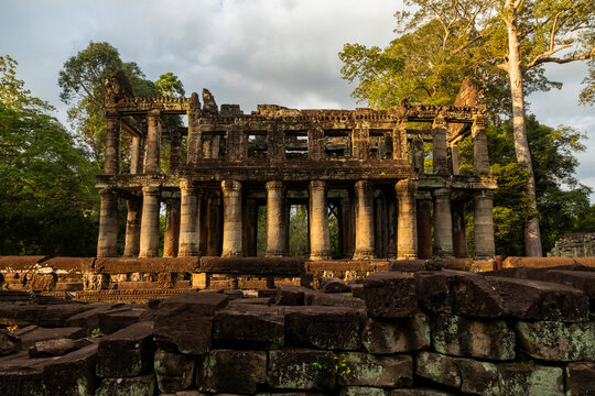 Ancient temple ruins stand beneath golden afternoon light, Preah Khan, Angkor, Cambodia