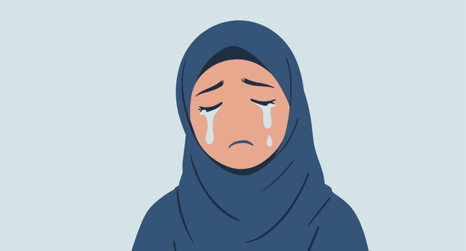 Sad woman wearing a blue hijab crying.