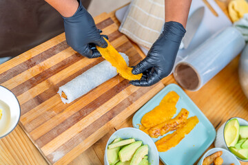 Chef hands preparing peruvian japanese fusion maki sushi © Guillermo Spelucin
