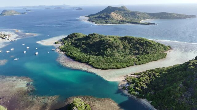 Horizontal panning drone shot of Maapdit Island in the morning, highlighting calm waters and deep to shallow water contrast, Philippines