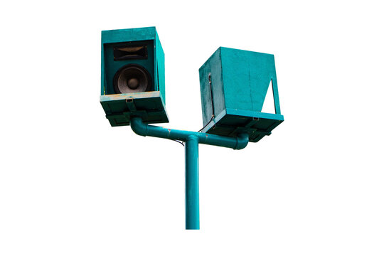 Address loudspeaker mounted green old on metal pole in park environment. Twin speakers for announcements, safety warnings, and communication systems. Isolated on cutout PNG or transparent background.