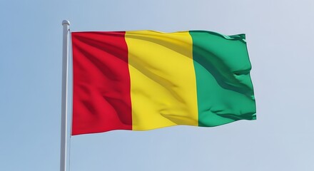 Fototapeta premium National flag of guinea waving in the wind against a clear blue sky