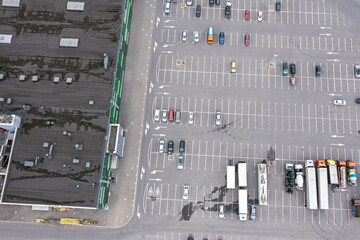 aerial view of cars at large outdoor parking lot near city shopping mall. drone photo.