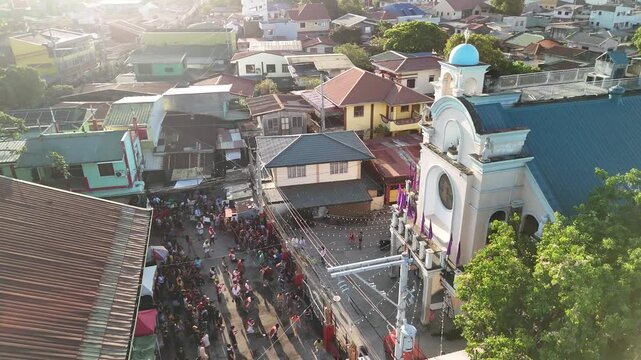 Aerial drone footage of Filipino SinaKulo Pinetensya during Holy Week in front of a parish church, highlighting powerful religious devotion and cultural heritage. Captures dramatic passion play