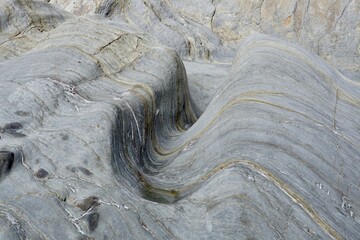 Waves from the ocean corroded rock in to a wave shape over many years creating an interesting smooth image I rock © Joseph