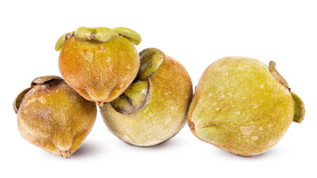 Velvet apple fruits mabolo tropical fuzzy skin ripe yellow brown organic exotic fruit isolated fresh harvest natural sweet Asian produce closeup