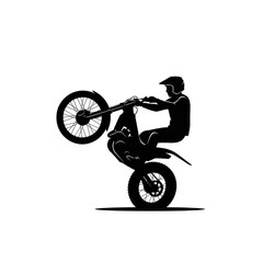 Obraz premium Motocross Rider Performing a Wheelie Stunt Silhouette.