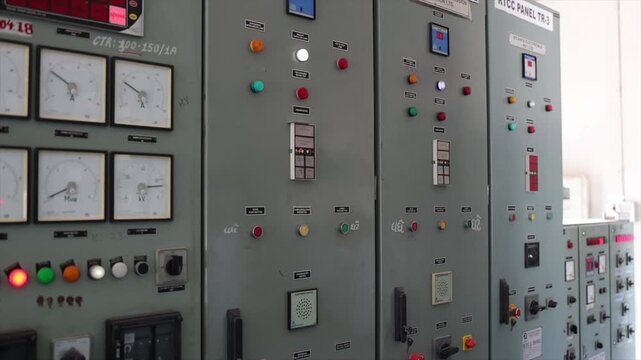 Close Up of Electrical Control Panel with Analog Gauges Indicator Lights and Switches in Factory.
