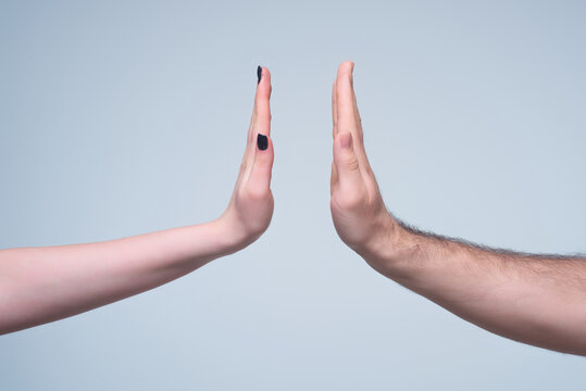 High five gesture showing teamwork and success. Hands meeting with unity and cooperation concept. Closeup interaction with support and connection. Simple studio image with agreement and motivation.