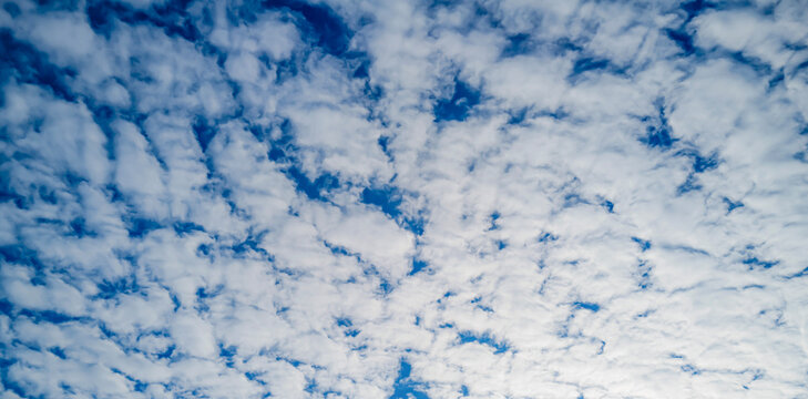 Sun on the puffy clouds. Sky view. Sunny sky. Background with clouds on blue sky.