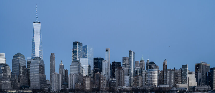NYC Manhattan skyscrapers panoramic cityscape. NYC Manhattan skyline wide banner. NYC Manhattan skyline with glass towers. NYC Manhattan skyline urban landscape.