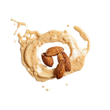 Almonds butter spread whole nuts with a creamy splash of nut paste isolated on a transparent background