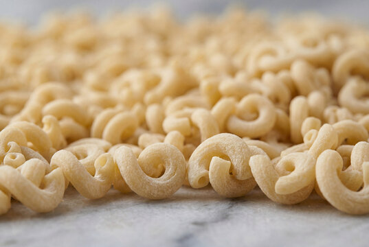 Abundant uncooked gramigna pasta creating a captivating texture
