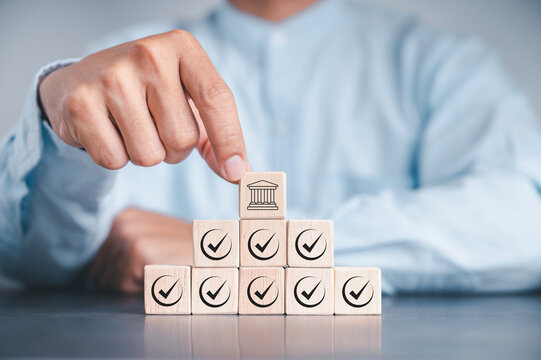 Regulation and good governance for transparent, accountable, and sustainable business operations. Wooden blocks with check marks, symbolizing corporate regulatory and compliance, ethical corporate.