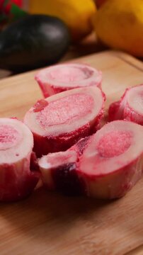 Raw Beef Marrow Bones Close-Up on Cutting Board for Cooking 