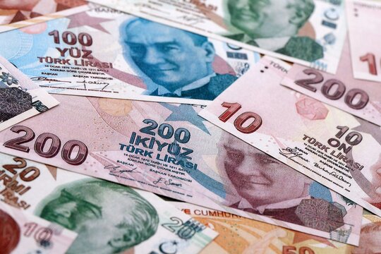 Turkish lira money bills pile on table. Turkey banknotes of TRY currency close up.