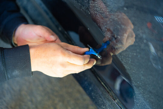 Removing dents on the car. PDR technology. Car body repair without painting.