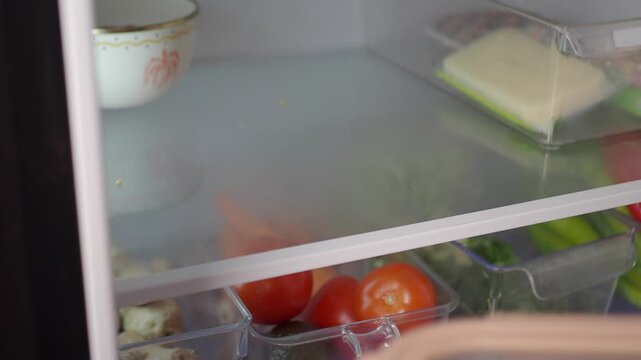 Organizing food items in the refrigerator for better storage