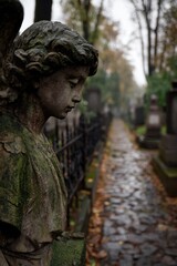 Fototapeta premium Weathered angel statue in a quiet Warsaw cemetery at dusk