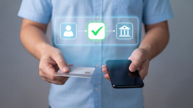 A person demonstrates digital banking and payment processing with a card and phone.