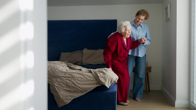 Daughter taking care of ill old mother.