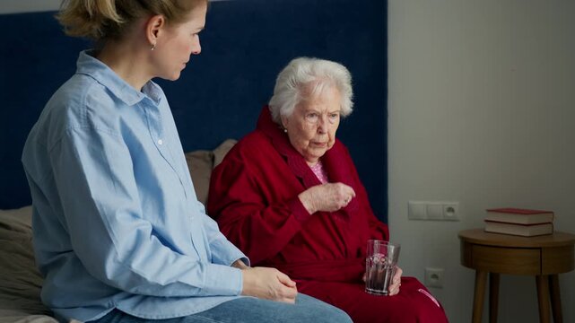 Daughter taking care of ill old mother.