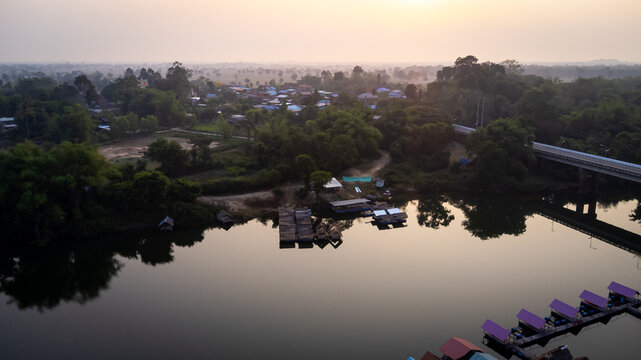 A tourist destination, a holiday retreat, a river, trees, a perfectly balanced and beautiful landscape, eco-friendly relaxation, photographed from a drone.
